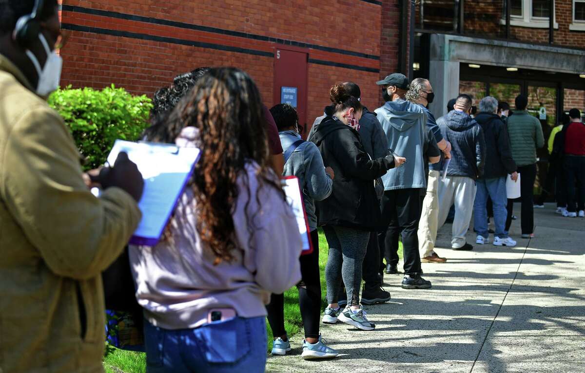 Local residents line up for the The Griffin Hospital mobile COVID-19 vaccination clinics at the Norwalk Public Library main branch on Belden Ave. Tuesday, April 20, 2021, in Norwalk, Conn. NORWALK — Around 250 people received their first dose of the Moderna COVID-19 vaccine at a mobile vaccination clinic at the Norwalk Public Library main branch Tuesday. The mobile clinic, operated by Derby’s Griffin Hospital in partnership with the Department of Public Health, will be stationed throughout Norwalk for the week of April 19-23, city spokesperson Josh Morgan previously said.