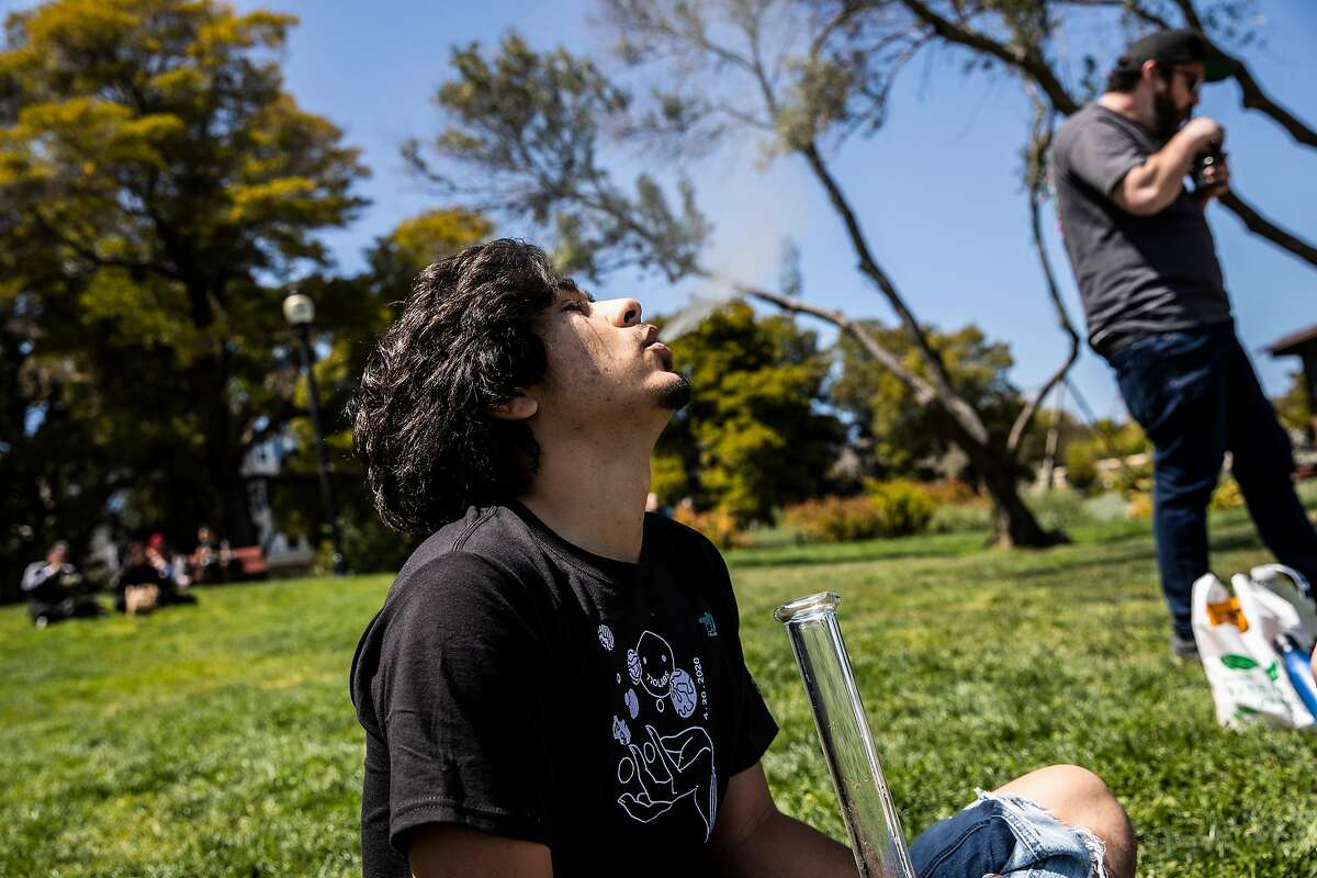 Ernie Gonzales exhales while consuming marijuana during the annual observance of 4/20 for cannabis consumption at Mission Dolores Park in San Francisco, California Tuesday, April 20, 2021.