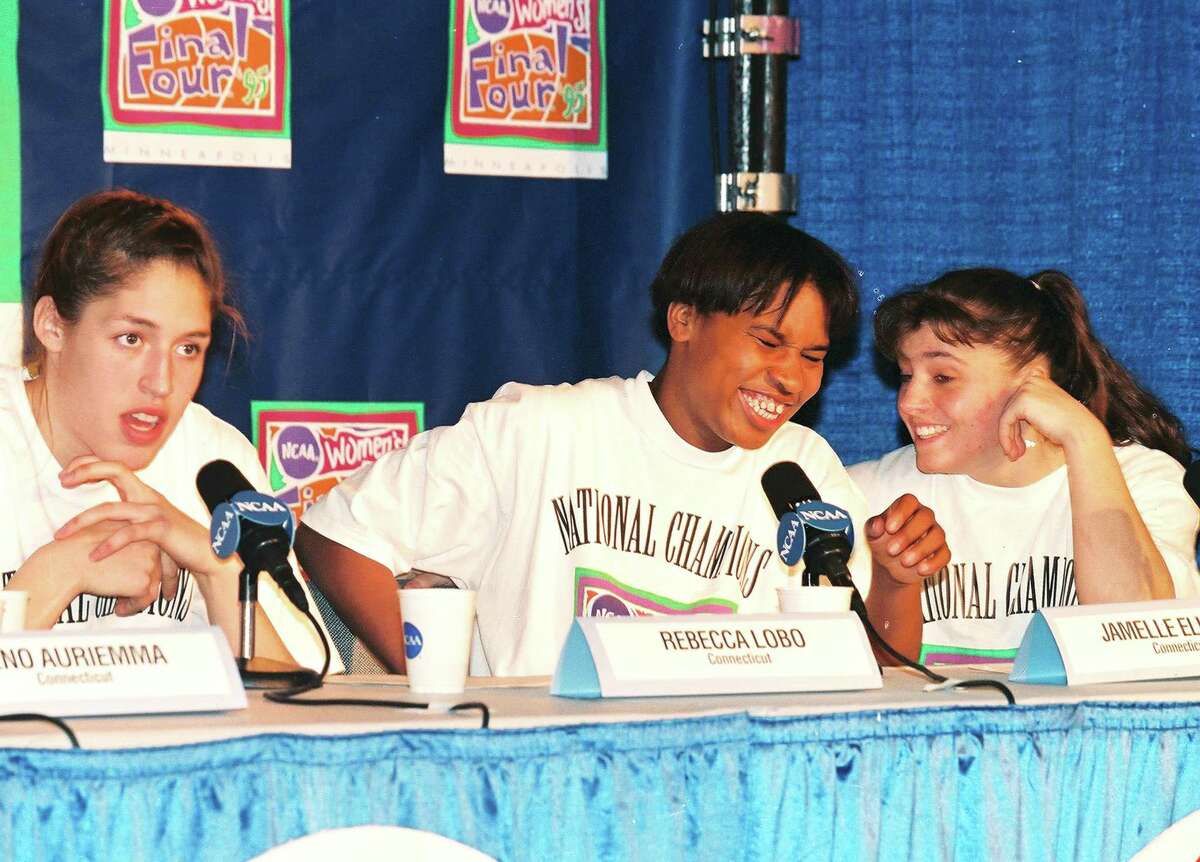 American basketball players, from left, Rebecca Lobo, Jamelle Elliott, and Jennifer Rizzotti, all from the University of Connecticut, share a laugh at a press conference after their victory in the NCAA Women's National Championship, Storrs, Connecticut, 1995. (photo by Bob Stowell/Getty Images)