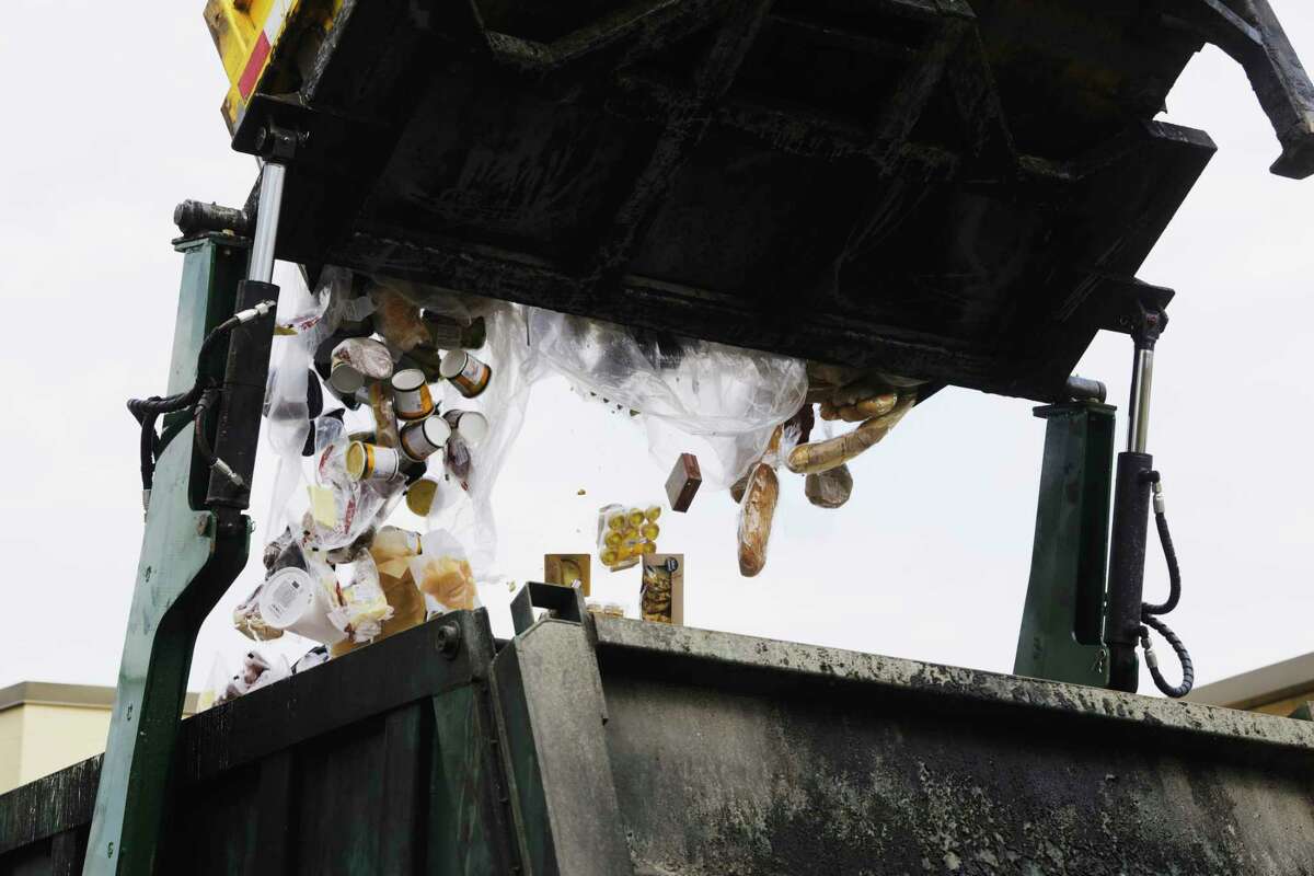 Food waste is dumped into an Agri-Cycle truck outside the Hannaford Supermarket on Tuesday, April 20, 2021, in Albany, N.Y. Agri-Cycle collects food that can not be sold or donated to a food bank and uses the food waster for renewable energy and through the process they use they also create an organic fertilizer. (Paul Buckowski/Times Union)