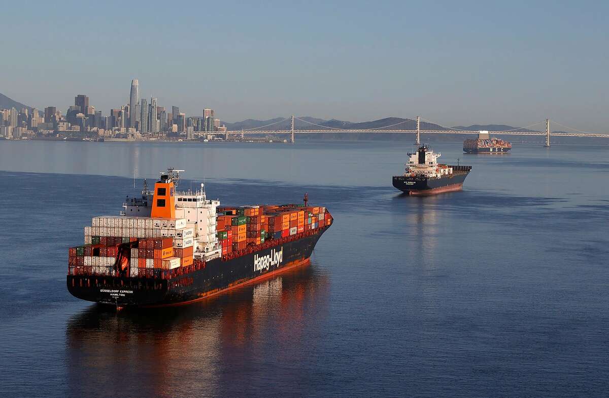 Container ships sit idle in the the San Francisco Bay just outside of the Port of Oakland on March 26, 2021.
