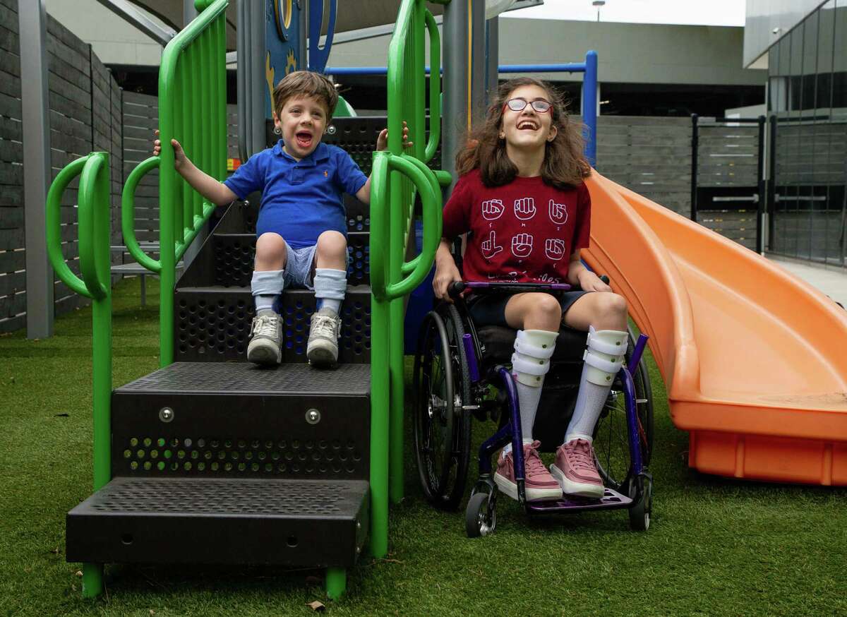 Jack Grodin, 5, and Avery Reilly, 13, pose for a photograph on the playground at The Caroline School, on Wednesday, April 7, 2021, in Houston. Jack and Avery are ambassadors for the Easter Seals Greater Houston's Walk With Me event - which is celebrating its 10th anniversary - to raise money for those with disabilities.