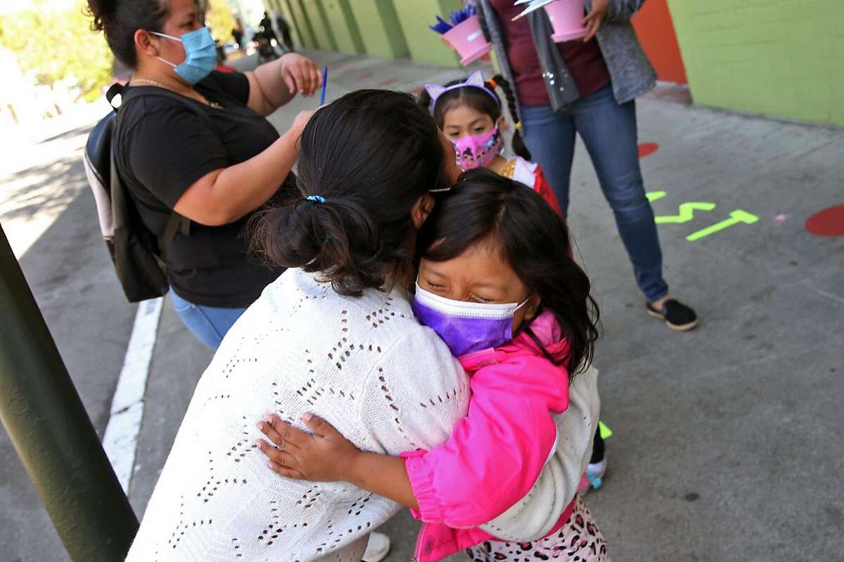 Merlin Momotiz gets a hug from her daughter Ashley Poz at Bryant Elementary School in San Francisco on April 20.