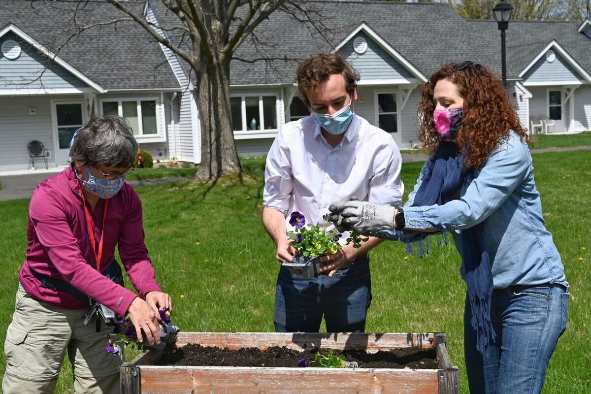 Elected officials from Ridgefield joined more than 40 volunteers on April 18 to "plant" democracy at Ballard Green Senior Housing in honor of Earth Day.