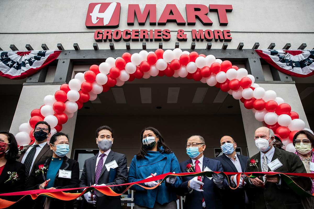 San Francisco Mayor London Breed, center, leads a ribbon-cutting ceremony with other dignitaries during the long-anticipated grand opening of H Mart in the Ingleside Heights neighborhood of San Francisco, California Wednesday, April 21, 2021.