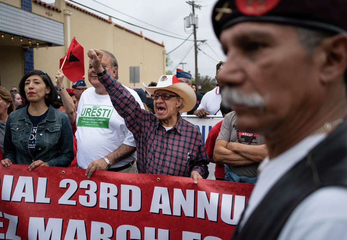 Teodoro Zamora, center, cheers with 