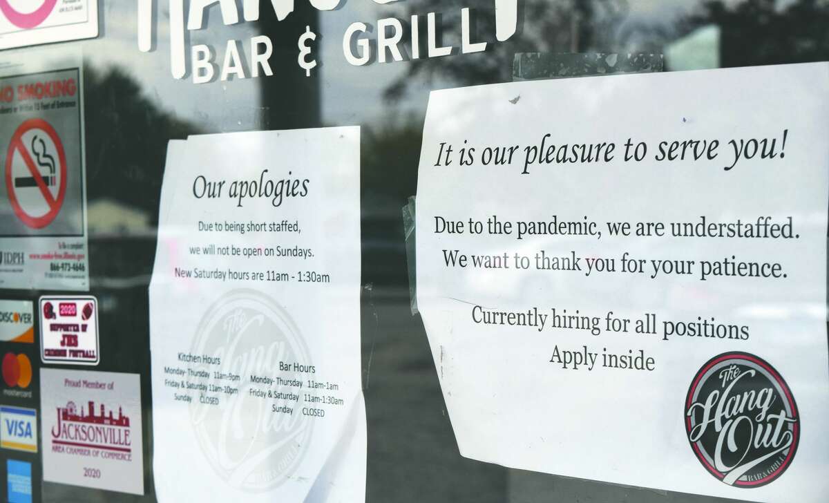 Signs on the front door at The Hangout Bar and Grill note reduced days and hours because of being short-staffed. 