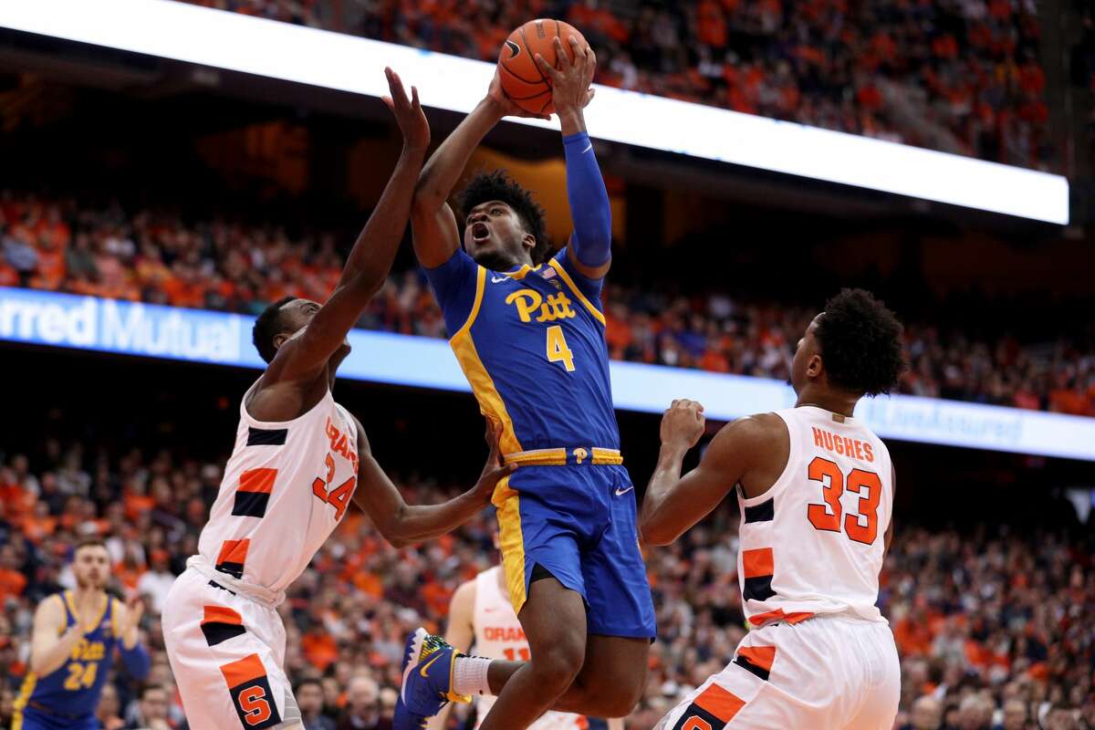 SYRACUSE, NEW YORK - JANUARY 25: Gerald Drumgoole Jr. #4 of the Pittsburgh Panthers drives to the basket as Bourama Sidibe #34 and Elijah Hughes #33 of the Syracuse Orange defend him during the first half of an NCAA basketball game at the Carrier Dome on January 25, 2020 in Syracuse, New York. (Photo by Bryan Bennett/Getty Images)