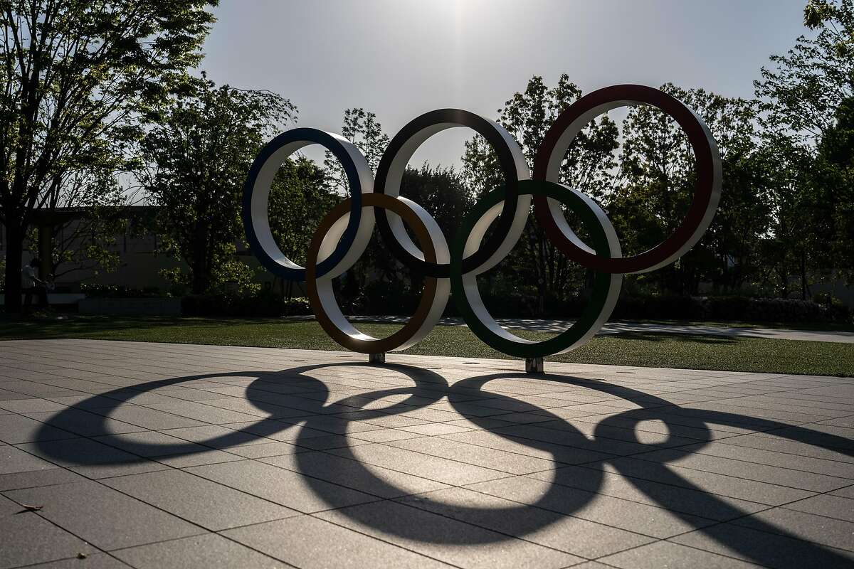 TOKYO, JAPAN - APRIL 21: A shadow is cast as the sun sets behind the Olympic Rings on April 21, 2021 in Tokyo, Japan. The Japanese government is expected to impose a third state of emergency in Tokyo soon amid an increase in cases of Covid-19 coronavirus in what experts have said is the fourth wave of the virus to hit the country. Prime Minister Yoshihide Suga has stated that any declaration would not affect the hosting of the Olympics which are now only three months away. (Photo by Carl Court/Getty Images)