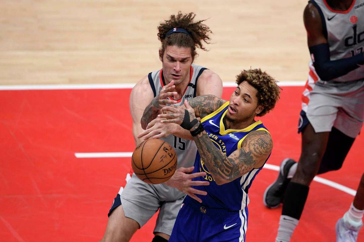 Warriors guard Kelly Oubre Jr. battles for the ball with Wizards center Robin Lopez during the second half in Washington, D.C.