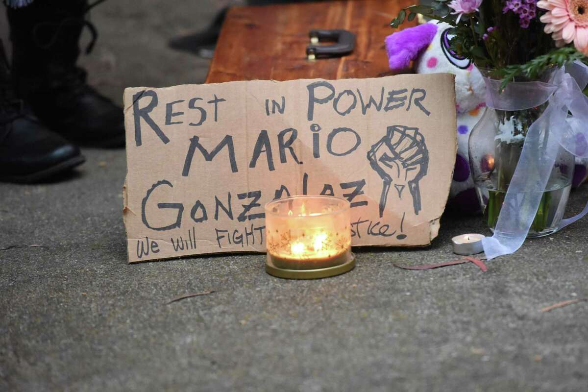 A sign reads “Rest in Power Mario Gonzalez” during a press conference to demand answers from Alameda police about the death of Mario Gonzalez in Alameda, Calif. on Wednesday, Apr 21, 2021. Gonzalez, a father and caretaker, died in Alameda police custody Monday and his family has heard nothing about the cause of his death.