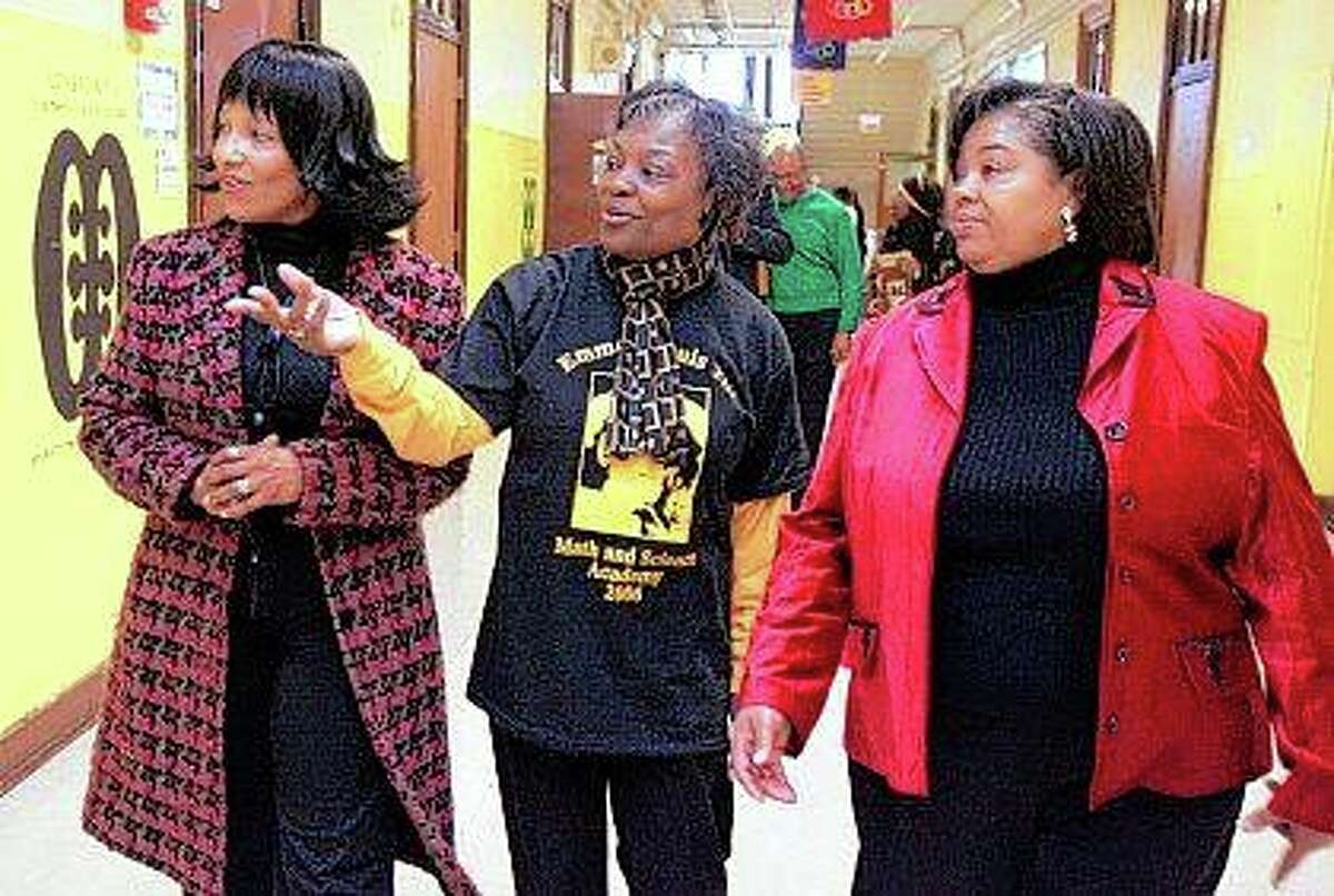 Deborah Watts (left) and Ollie Gordon (right), both cousins of Emmett Till, accompany principal Mary Rogers in February 2006 as they walk through a hallway at Chicago’s Emmett Louis Till Math & Science Academy, which honors the 14-year-old former student. Till’s lynching galvanized the civil rights movement. The death of George Floyd, the Black Minneapolis man killed by police, sparked a worldwide call for racial justice. The deaths of Till and Floyd are separated by more than six decades, but their families feel a deep connection in their grief.