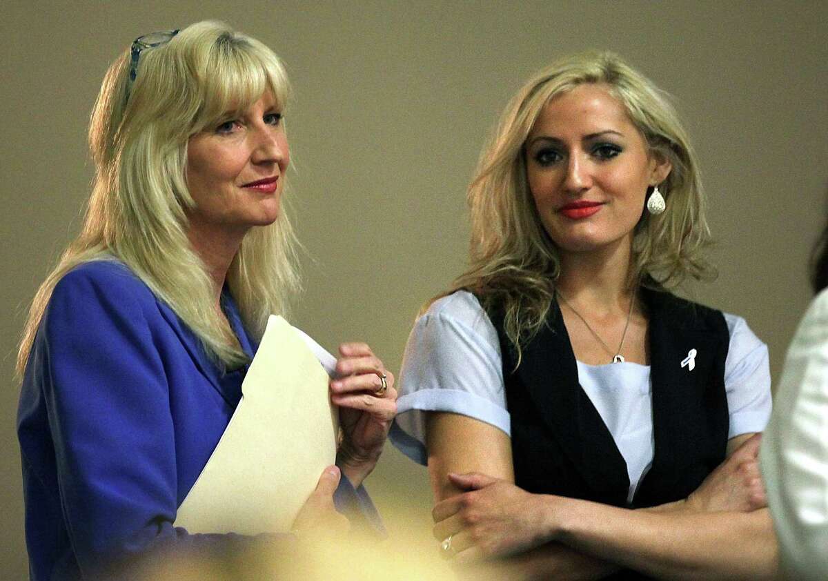 Kelly Quinn, left, fights back tears as she joins her daughter Jenna Quinn on stage after speaking at The ChildSafe Conference on Child Abuse in San Antonio, Thursday, April 26, 2012. The mother daughter team shared Jenna's story about being a sexually abused teen victim who became the empowered champion of 'Jenna's Law', which mandates teachers, parents and students be made aware of the signs of child sexual abuse.
