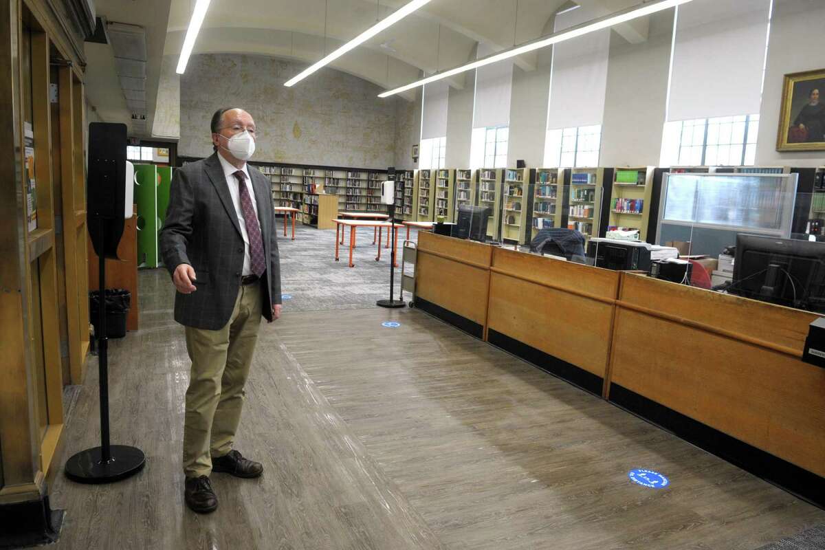 Assistant City Librarian John Soltis speaks during an interview in the main reading room of the Burroughs-Saden main branch library in downtown Bridgeport, Conn. April 21, 2021. The library will reopen to the public on Monday.