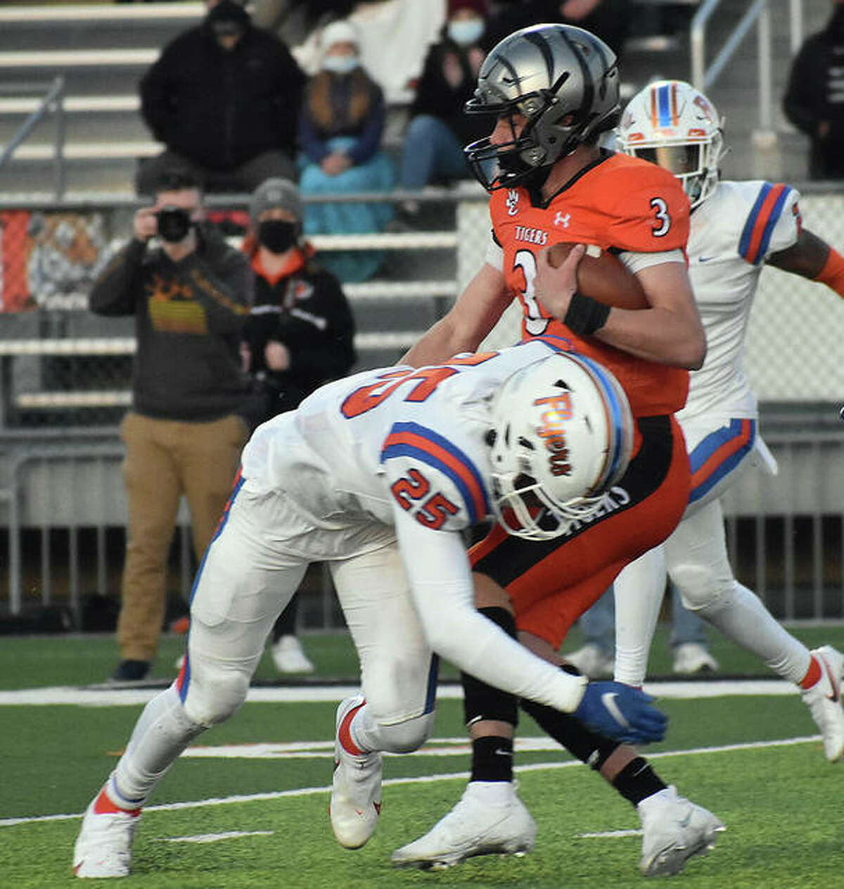 Edwardsville quarterback Ryan Hampton is tackled by East St. Louis safety Dallas Brown in the first quarter.