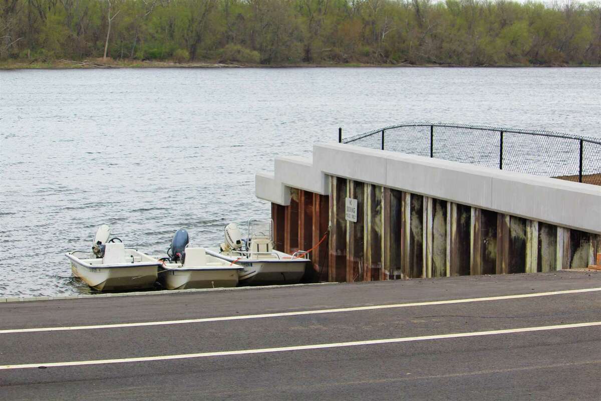The retaining wall at the Harbor Park fishing dock in Middletown is being reinforced with concrete at the Connecticut River.