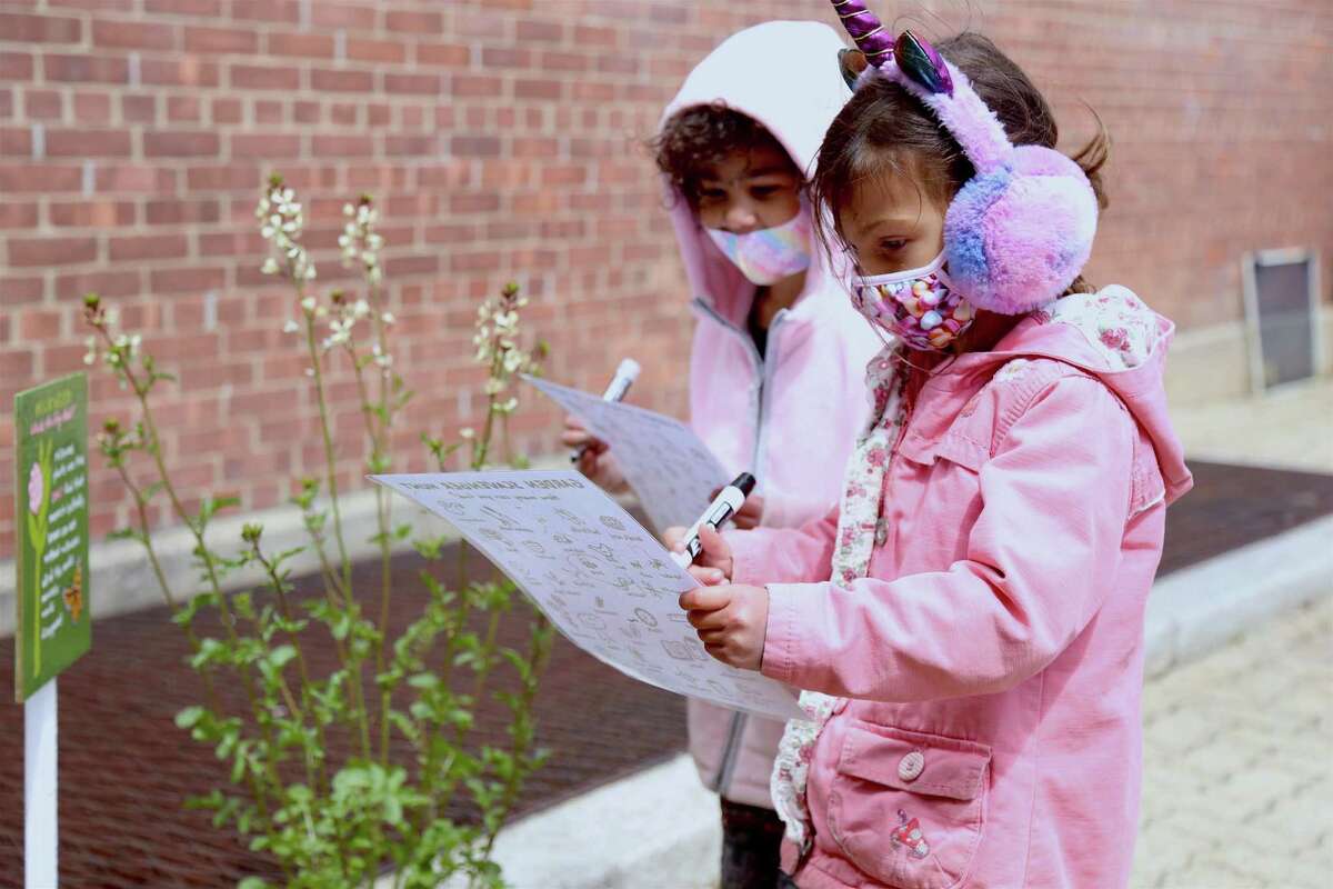 Olivia Esposito, 5, left, and Bethany Castillo, 5, work on the scavenger hunt at Tracey Magnet School on Thursday, April 22, 2021, in Norwalk, Conn.