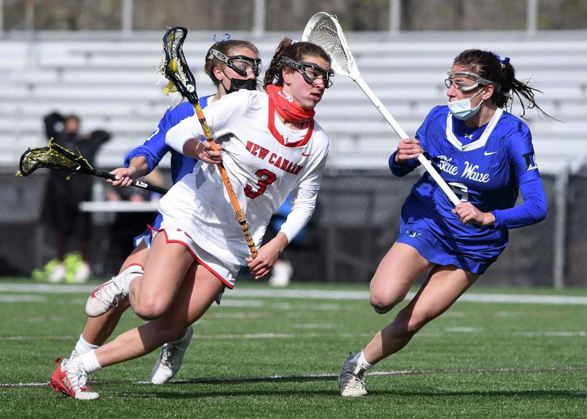 New Canaan’s Dillyn Patten (3) drives to the goal while Darien’s Sam Barlow (3) defends during Thursday’s game at Dunning Field in New Canaan.