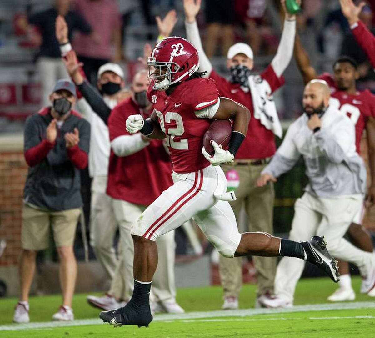 Alabama running back Najee Harris (22) scores a touchdown on a long run against Auburn during an NCAA college football game Saturday, Nov. 28, 2020, in Tuscaloosa, Ala. (Mickey Welsh/The Montgomery Advertiser via AP)