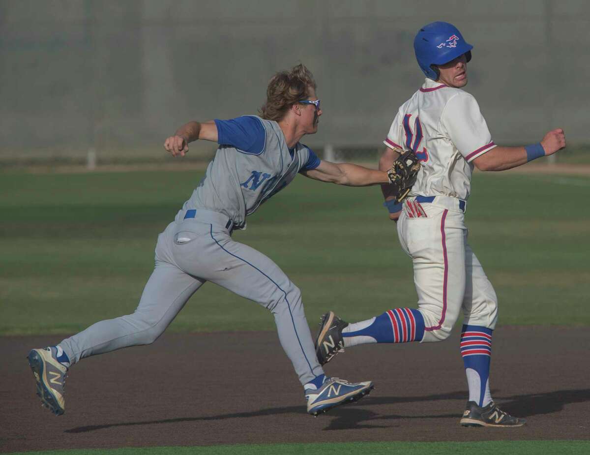 Midland Christian's Rhett Clark is tagged out in a run down between first and second by FW Nolan Catholic's Henry Doskocil but not before Clark extended the play the to allow a run to score 04/23/2021 at Christensen Stadium. Tim Fischer/Reporter-Telegram