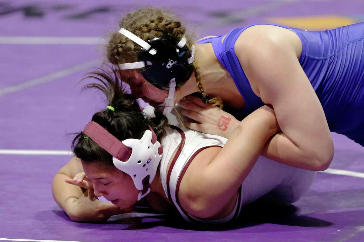 Avery Beckman of Friendswood (top) works to pin Jazmine Garcia of El Paso Ysleta in the 148-pound weight class championship match at the UIL Girls 5A State Wrestling Championships Friday at the Berry Center.