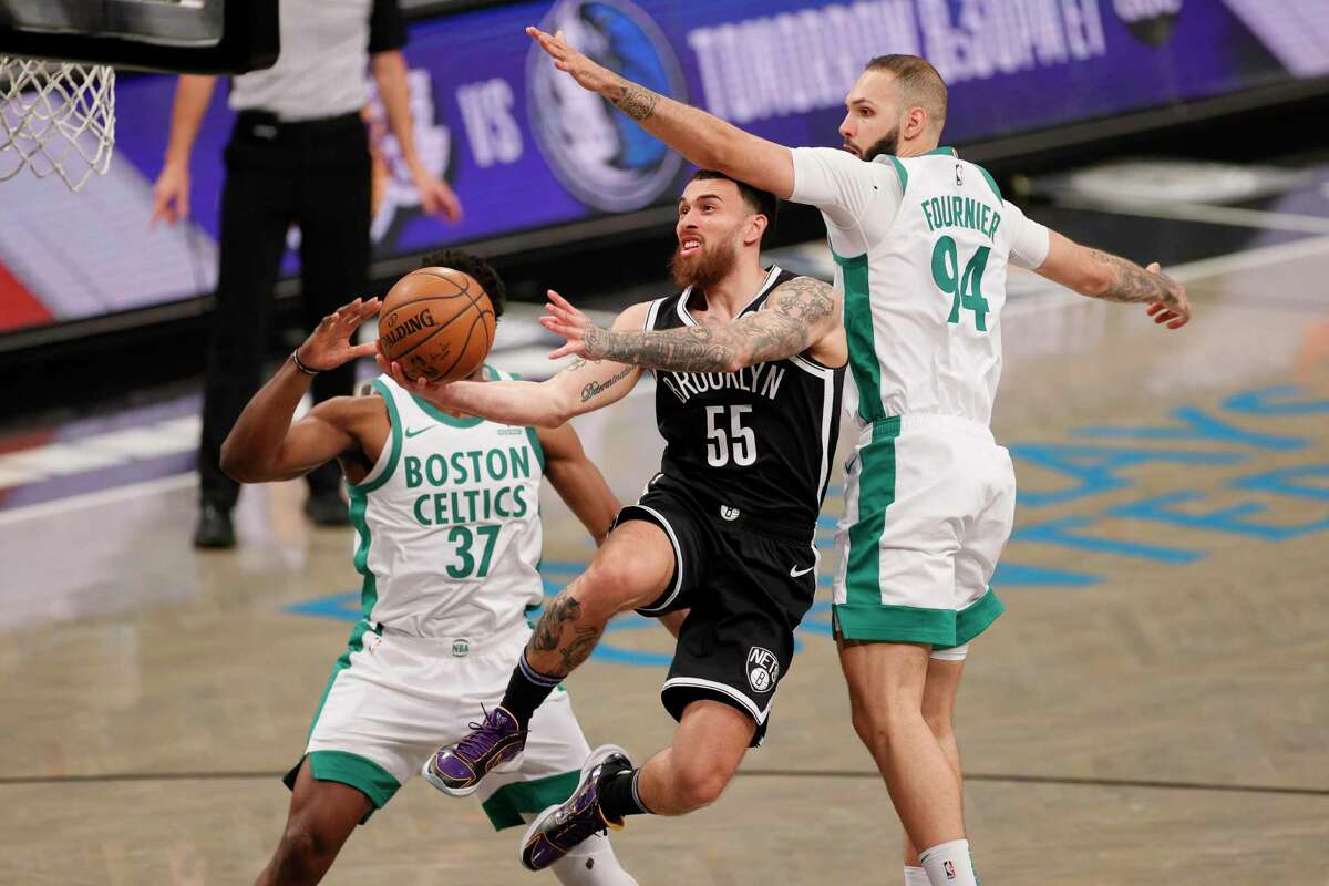 NEW YORK, NEW YORK - APRIL 23: Mike James #55 of the Brooklyn Nets goes up to the basket as Semi Ojeleye #37 and Evan Fournier #94 of the Boston Celtics defend during the second half at Barclays Center on April 23, 2021 in the Brooklyn borough of New York City. NOTE TO USER: User expressly acknowledges and agrees that, by downloading and or using this photograph, User is consenting to the terms and conditions of the Getty Images License Agreement. (Photo by Sarah Stier/Getty Images)