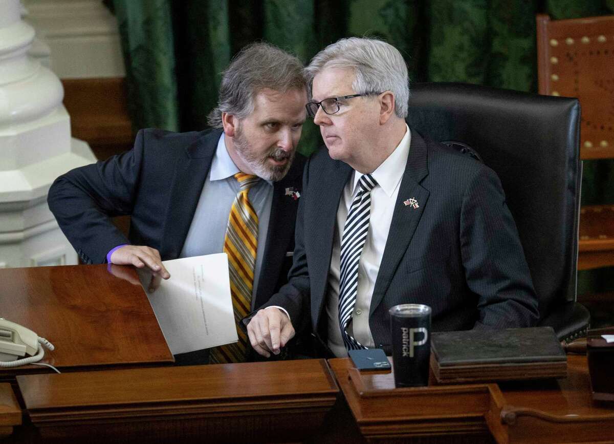 Texas State Sen. Bryan Hughes, R - Mineola, left, talks to Lt. Gov. Dan Patrick after Hughes' anti-abortion bill passed in the Senate Chamber at the Capitol on Tuesday, March 30, 2021. (Jay Janner/Austin American-Statesman via AP)