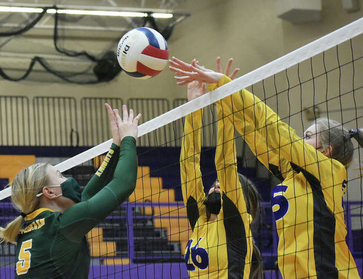 Metro-East Lutheran’s Peyton Ashauer, left, goes up for the ball against Civic Memorial’s Camryn Gehrs, center, and Annabelle Reno.