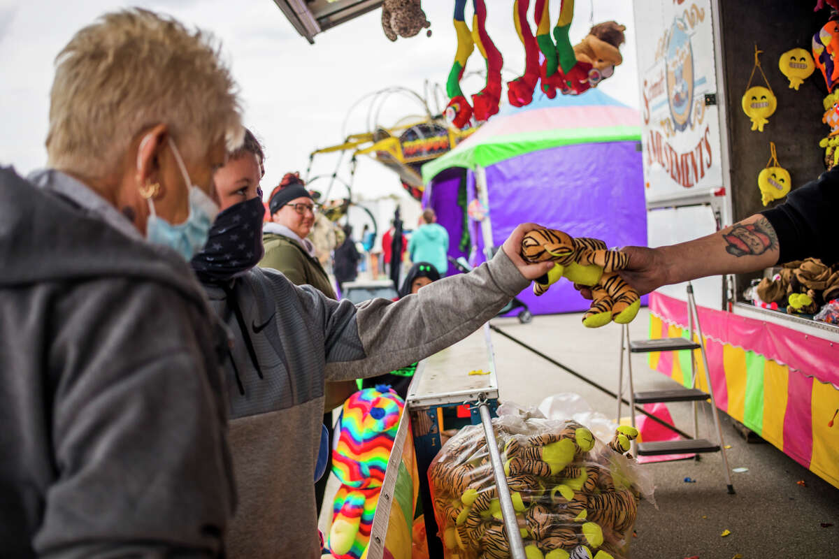 Families enjoy carnival rides, games, food and prizes at the annual Freeland Walleye Festival Saturday, April 24, 2021 at Burt Watson Chevrolet in Freeland. (Katy Kildee/kkildee@mdn.net)