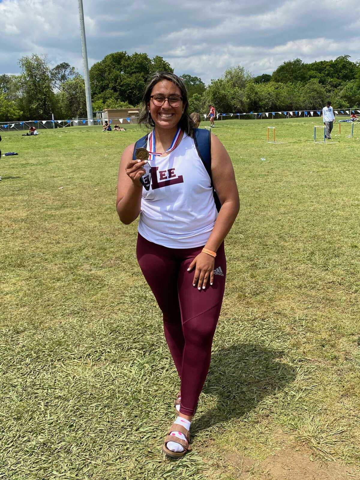 Lee sophomore Leah Acosta poses with her bronze medal after placing third in the girls discus at the Region I-6A track meet, Saturday in Arlington. 