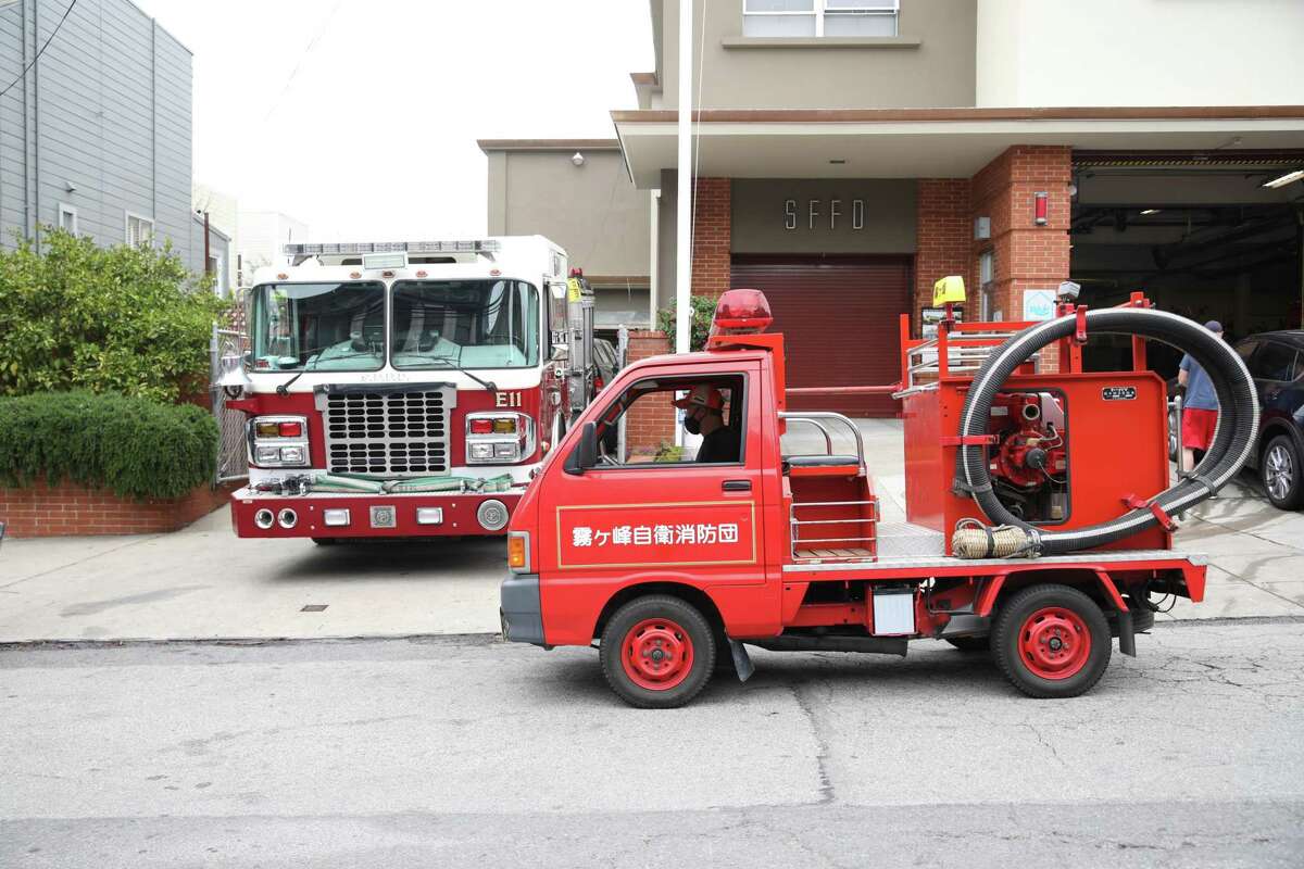 Todd Lappin drives his tiny Japanese fire truck in front of the San Francisco Fire Department’s Station 11. Shipped from Japan last year, Kiri the truck is 2 feet shorter than a Mazda Miata, climbs S.F. hills like a mountain goat and can actually fight fires.