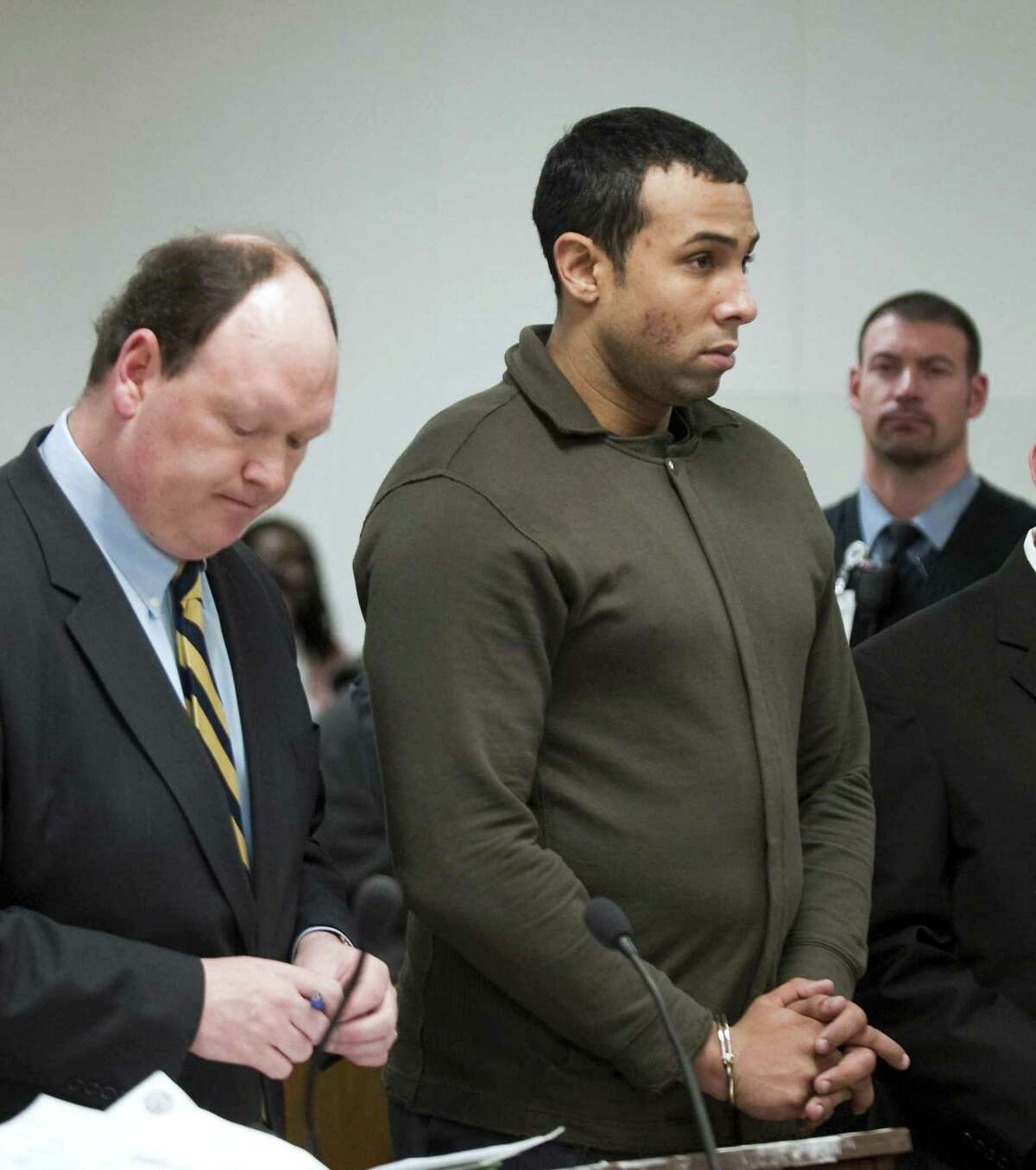 Defense Attorney, Daniel Ford, left, represents defendent and Probation Officer, Alphah East, center, during his arraignment in Norwalk, Conn. Superior Court Tuesday Jan. 12, 2009.