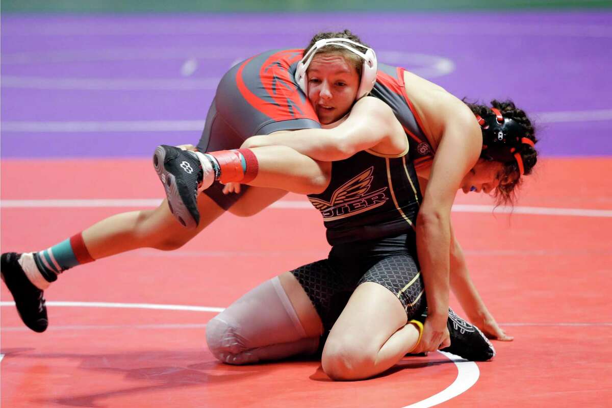 Emily Trevino with Mission Sharyland Pioneer, top, is taken down by Madison Canales with Richmond Foster in the 119 weight class of the UIL Girls 5A State Wrestling Championships Friday, Apr. 23, 2021 at the Berry Center in Cypress, TX.