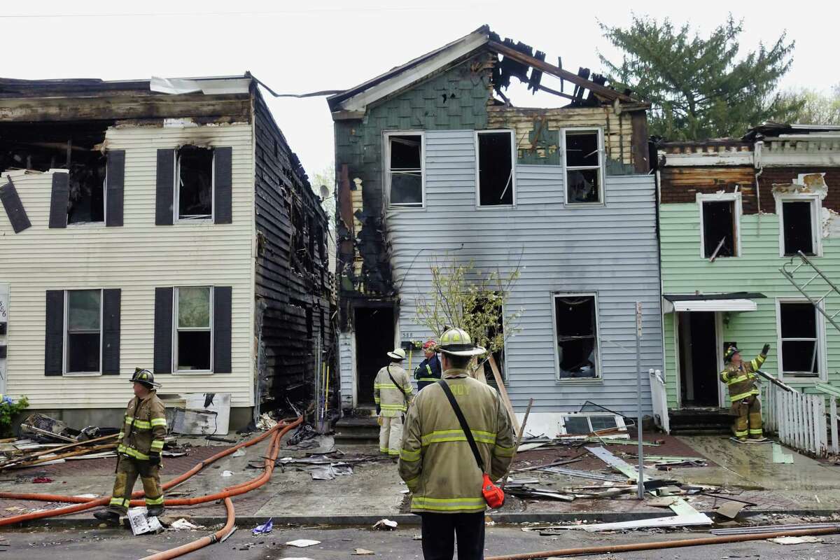 Troy Firefighters work at the scene of a fire in the 300 block of Fourth St. on Sunday morning, April 25, 2021, in Troy, N.Y. The fire damaged several buildings. (Paul Buckowski/Times Union)