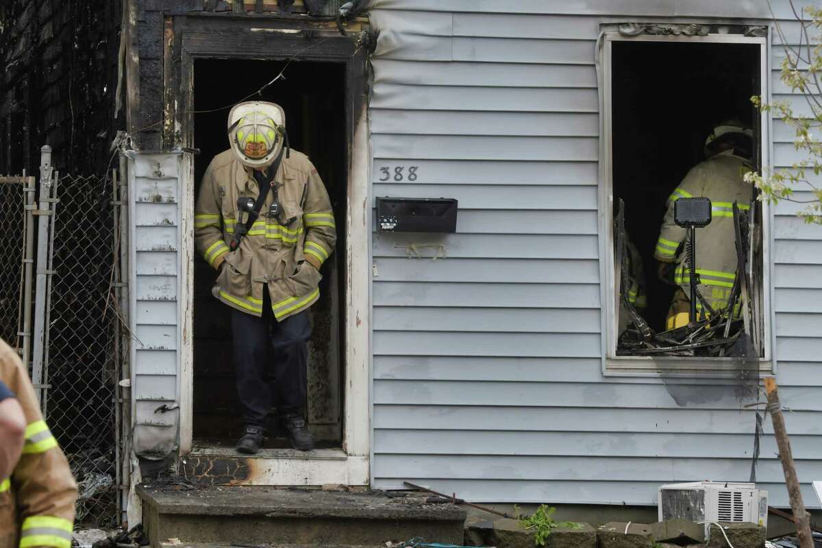 Troy Firefighters work at 388 Fourth St. as they investigate a fire on Sunday morning, April 25, 2021, in Troy, N.Y. The fire damaged several buildings. (Paul Buckowski/Times Union)