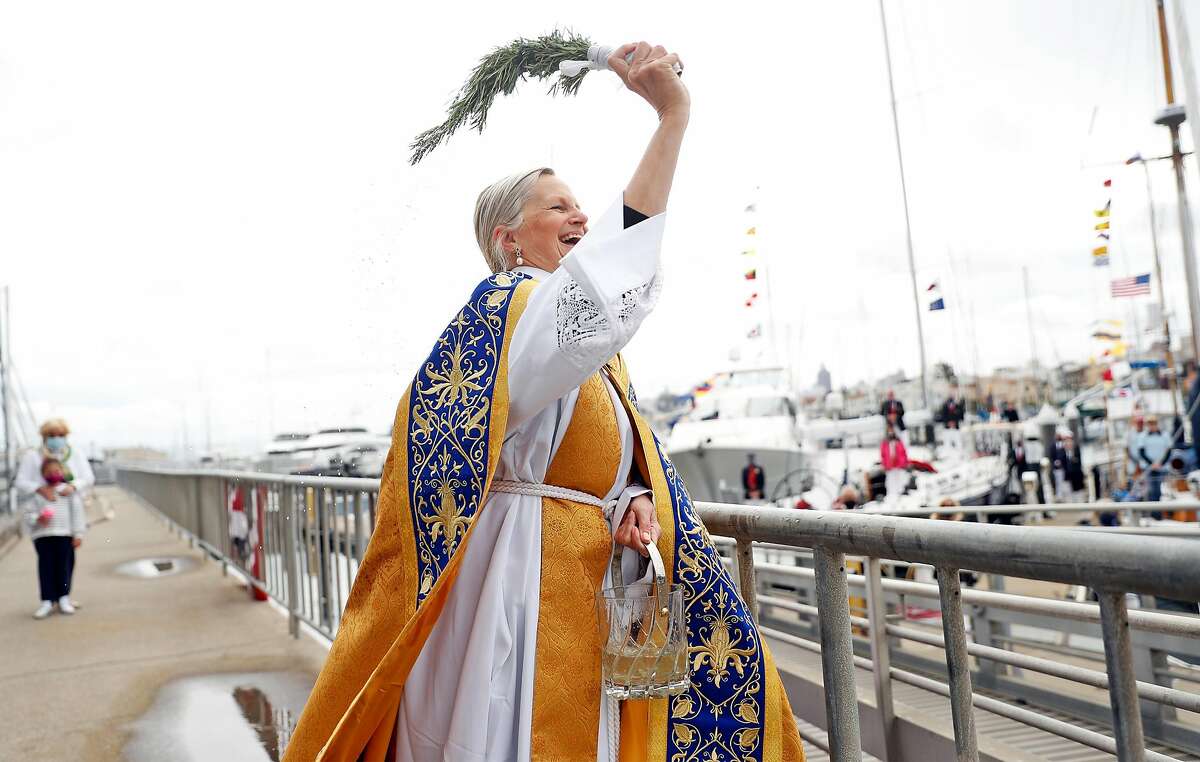 The Rev. Christine Trainor blesses the fleet on opening day of sailing season at St. Francis Yacht Club in San Francisco.