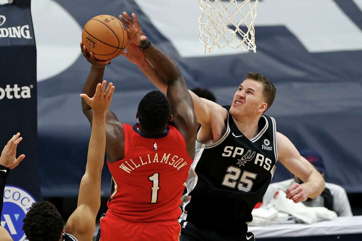 San Antonio Spurs center Jakob Poeltl (25) blocks a shot by New Orleans Pelicans forward Zion Williamson (1) in the second half of an NBA basketball game in New Orleans, Saturday, April 24, 2021. (AP Photo/Rusty Costanza)