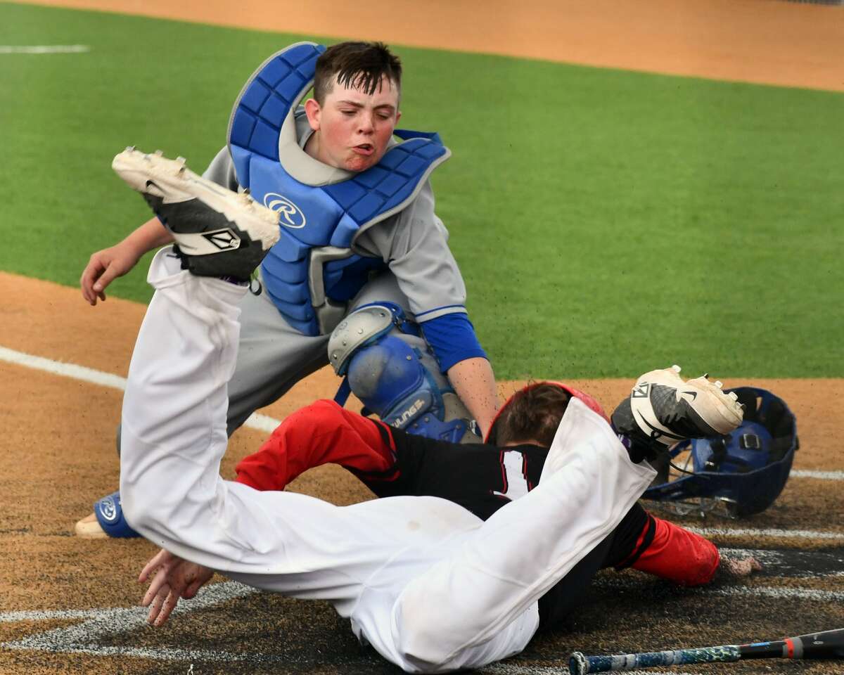 Olton catcher Brody Langford tries to apply the tag on Lockney base runner Malaki Alvis. 