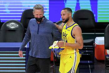 Stephen Curry (30) and head coach Steve Kerr share a smile after the Golden State Warriors defeated the Sacramento Kings 117-113 at Chase Center in San Francisco Calif., on Sunday, April 25, 2021.