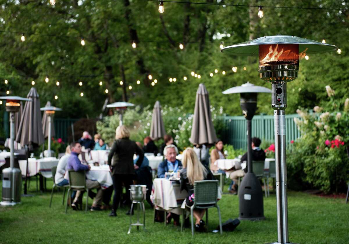 Outdoor dining in the garden behind Bernard’s in Ridgefield. Bernard's, Ridgefield