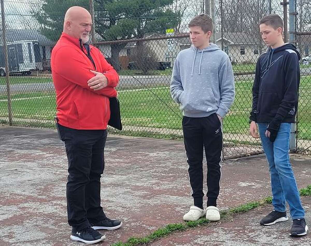 Bunker Hill school district architect Bill Tongay, left, talks with students Will Manar and Ethan Mullink about plans to restpre the school’s courts. Over the past four years, the two students have raised more than $70,000 for the project.
