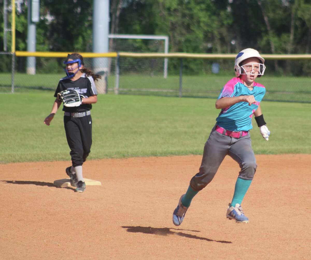Avery Lillard motors for third base after belting a two-RBI triple that proved to be the difference in the 10U Gold city championship game Sunday.