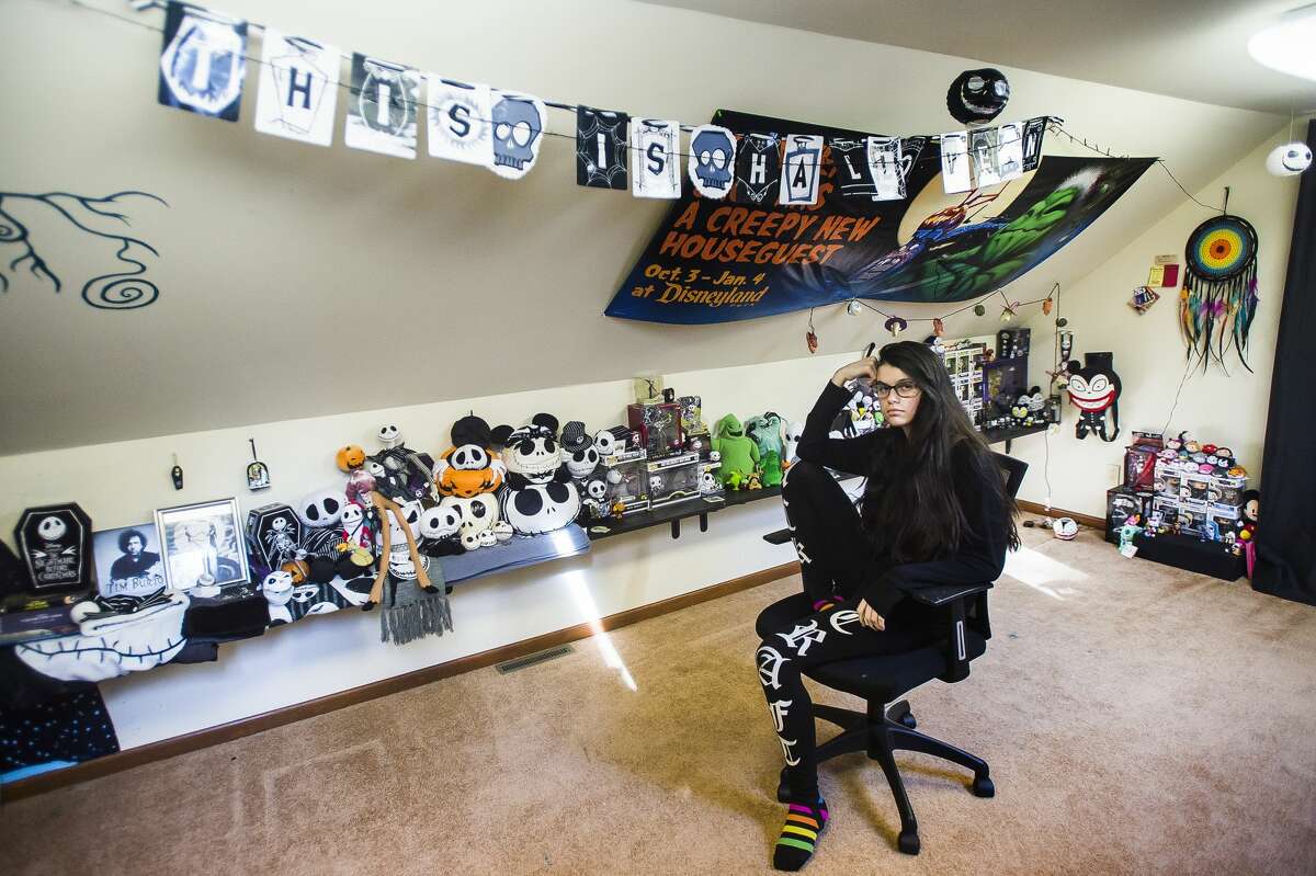 Gi Padavana poses for a portrait with her collection of "The Nightmare Before Christmas" memorabilia Thursday, Feb. 11, 2021 at her home in Midland. (Katy Kildee/kkildee@mdn.net)