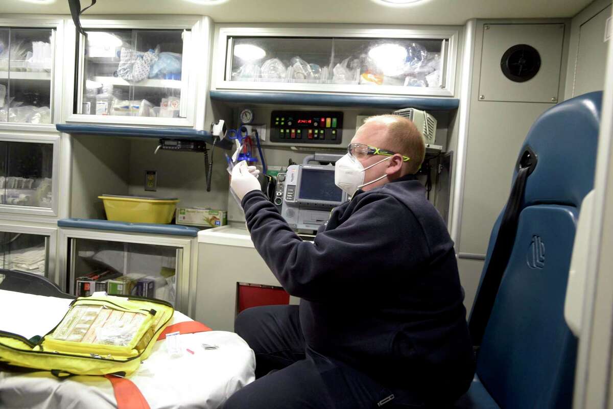 Nuvance Health ambulance EMS supervisor Andrew Matturro works in the back of his rig in April 2021.