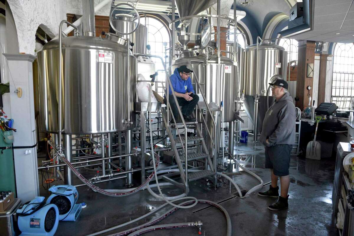 John Watson, right, brewer, and Dave Linari, assistant brewer finish off a batch at NewSylum Brewing Co., on the Fairfield Hill Campus in Newtown, Conn. They were brewing Therapy Session Pale Ale, on Monday, April 26, 2021.