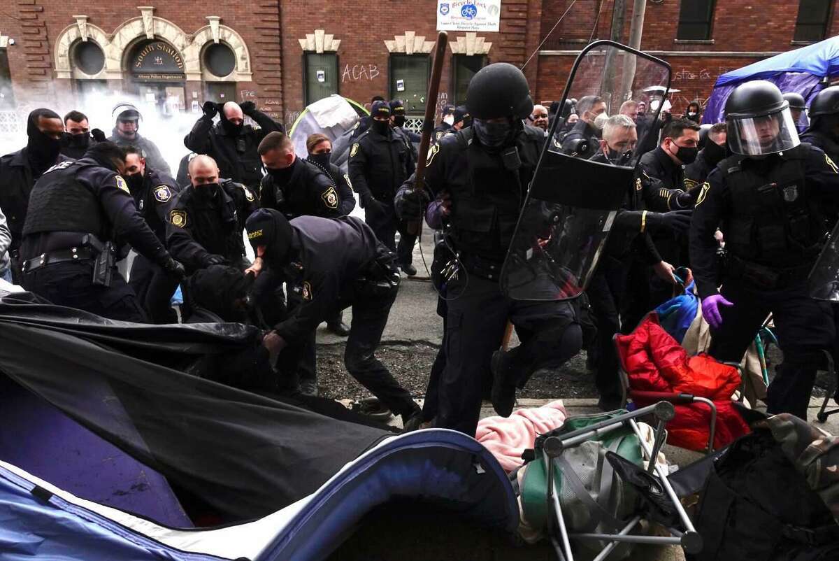 Albany police forcibly remove protesters from an encampment they created in front of South Station, April 22, 2021.