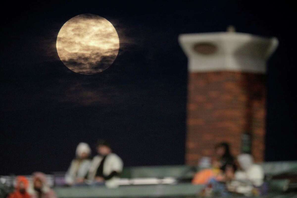 The Pink Super Moon rises over Levi's Landing as the San Francisco Giants played the Colorado Rockies at Oracle Park in San Francisco Calif., on Monday, April 26, 2021.