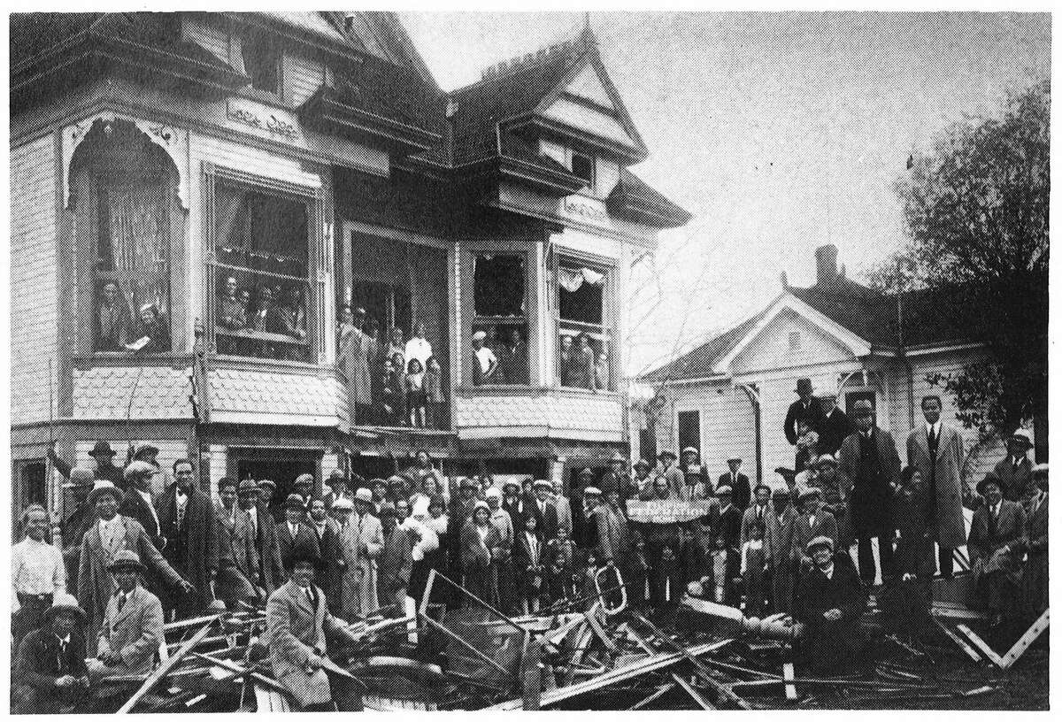Members of the Filipino Federation of America stand in front of their clubhouse following the Stockton bombing in 1930.