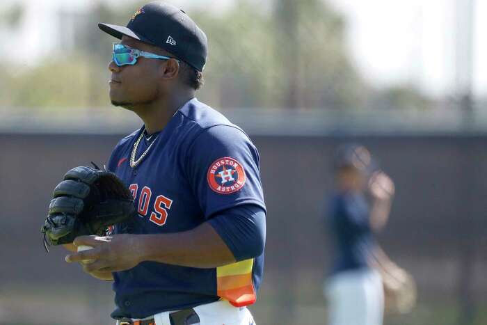 Seattle Mariners' Kyle Lewis (1) is greeted at the dugout by Taylor  Trammell, right, after Lewis hit a solo home run against the Houston Astros  during the second inning of a baseball