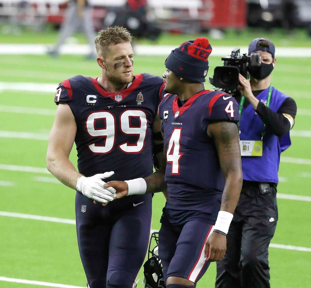 Houston Texans defensive end J.J. Watt (99) shakes hands with quarterback Deshaun Watson (4) walk back to the locker room after the Houston Texans 41-38 loss after the fourth quarter of an NFL football game Sunday, Jan. 3, 2021, at NRG Stadium in Houston .